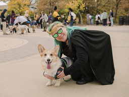 Woman dressed as the Sylvie Loki poses with her corgi dressed as President Loki.