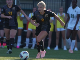 Two women's UMBC soccer players playing soccer.