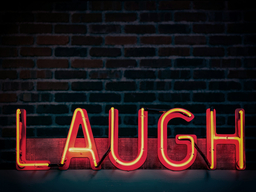 A black background with the word laugh in neon red letters.