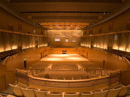 A concert hall bathed in warm light