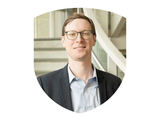 Photo of Dr. Cody Goolsby-Cole in UMBC shield shape.
