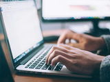 A picture of someone using laptop.