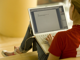 a woman uses a laptop computer to work on a task