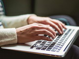 person typing on a laptop