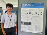 Nathaniel Glover stands next to the research poster he presented at the end of his internship at Argonne National Laboratory in summer 2024. (Photo courtesy of Glover)